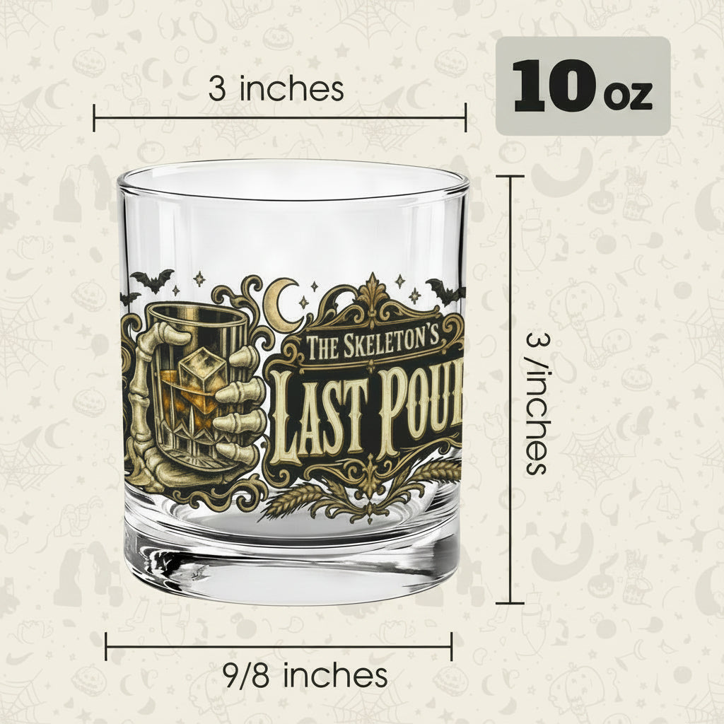 Skeleton hand gripping the glass beside an ornate Last Pour label on whiskey glasses, product view 3