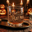 Skeleton hand gripping the glass beside an ornate Last Pour label on whiskey glasses, product view 5
