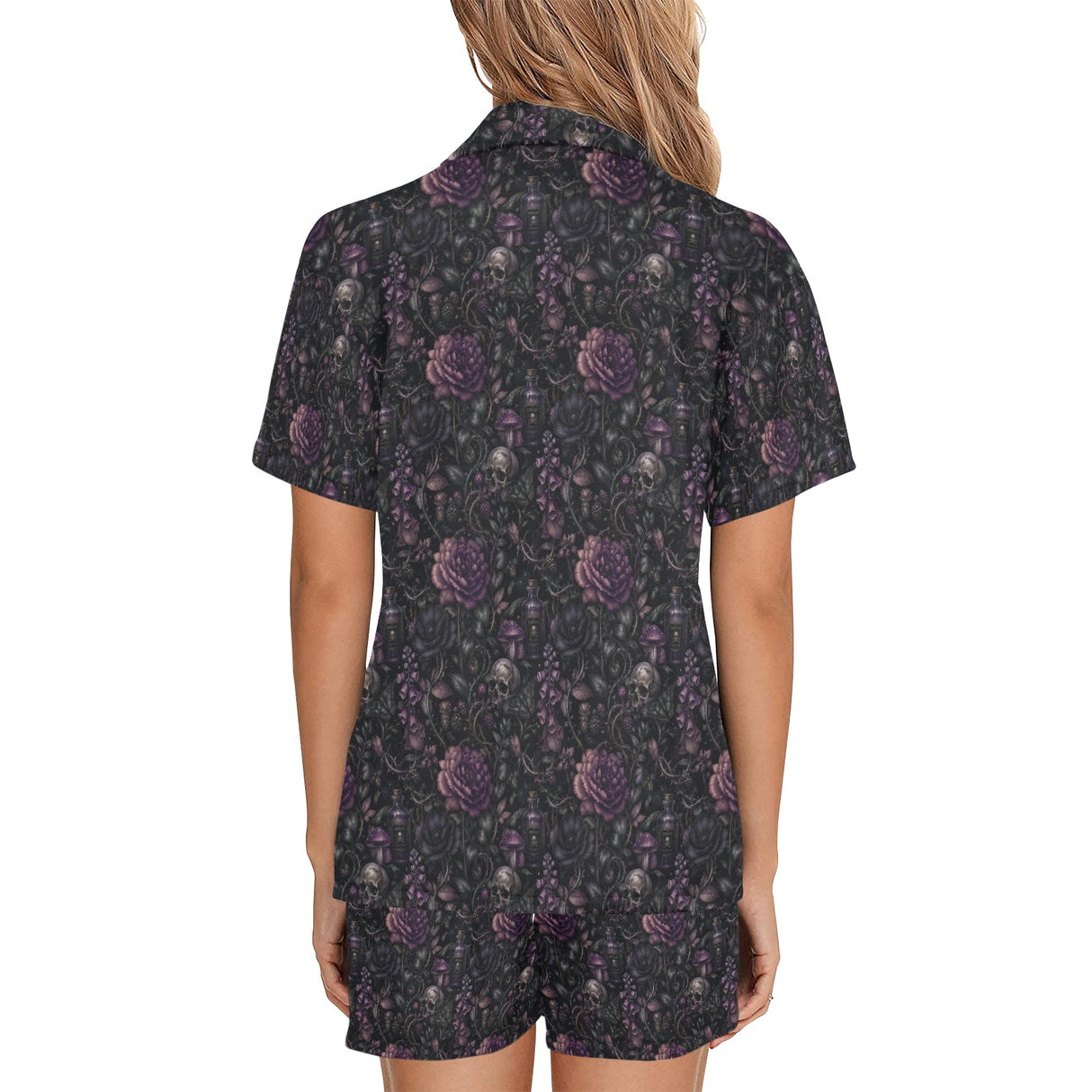 Back view of woman wearing black night floral short pajamas with purple skull-and-flower print