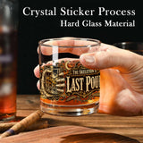 Skeleton hand gripping the glass beside an ornate Last Pour label on whiskey glasses, product view 4