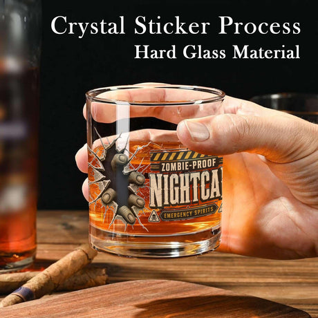 Zombie fingertips breaking through cracked glass beside a vintage nightcap label on whiskey glasses, product view 4