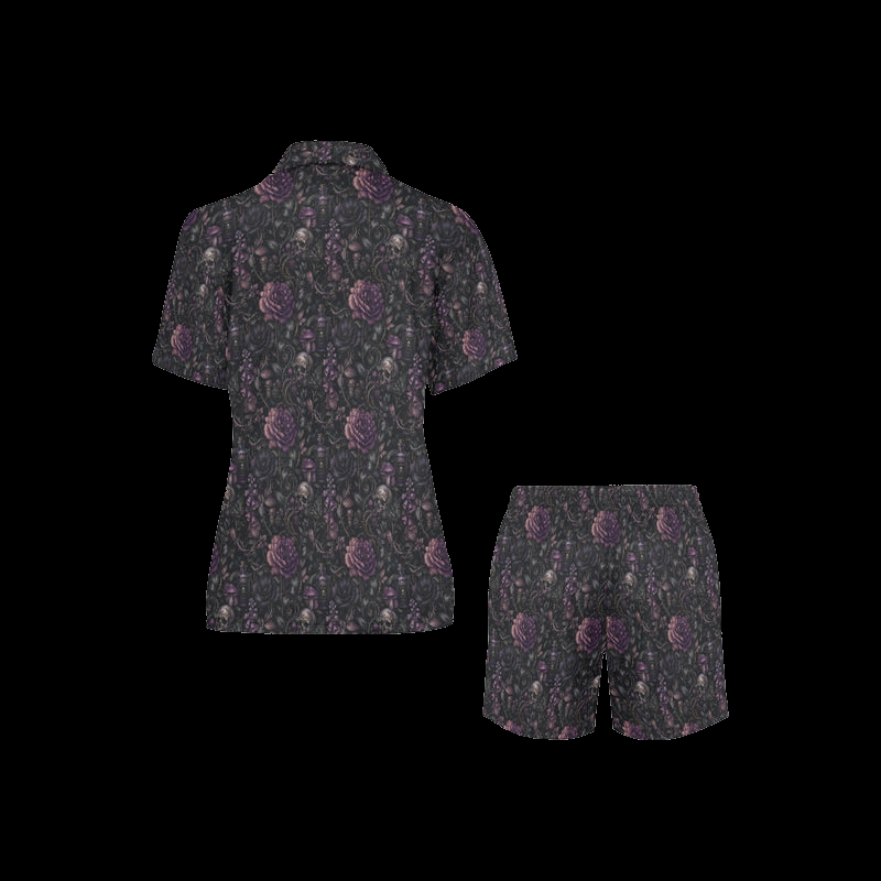 Back view of black night floral women's pajama shirt and shorts with purple skull-and-flower print on a black background
